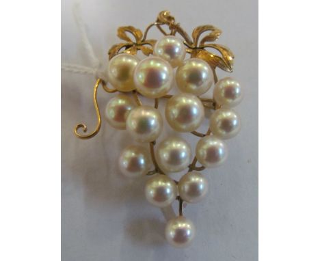 A pearl brooch in the form of a bunch of grapes on a mount marked K14