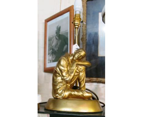 A gilt table lamp resting figure