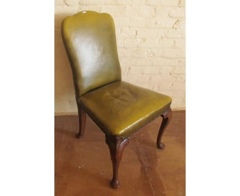 A 1920's green leather chair on oak cabriole legs
