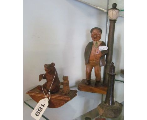 A blotter with two Black Forest bears seated on top, a treen bottle opener in the form of a man standing by lamp post and a l