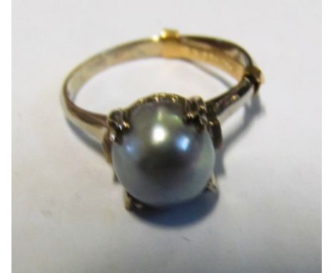 A pearl ring on mount marked K14