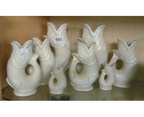 Eight white Dartmouth fish gargle jugs (s/a/f)