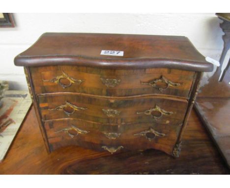 A three drawer mahogany jewellery box in the form of a serpentine commode