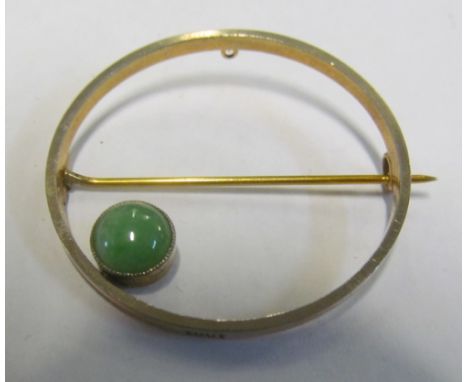 A 15ct gold circular brooch set single jade stone