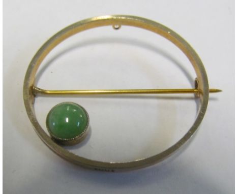 A 15ct gold circular brooch set single jade stone