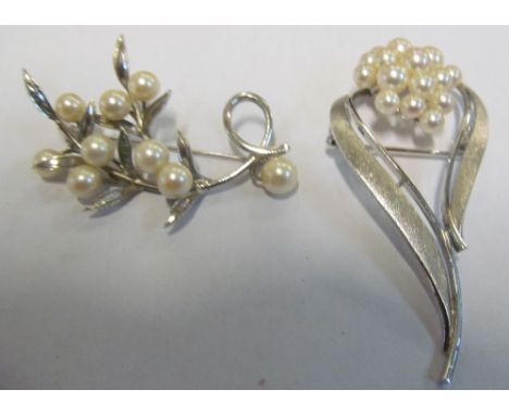 A pearl floral spray brooch and another stylish pearl brooch
