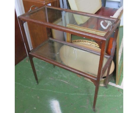 A mahogany two tier glass shelf trolley