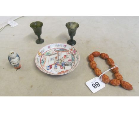 An oriental saucer, bracelet, porcelain netsuke and two small goblets