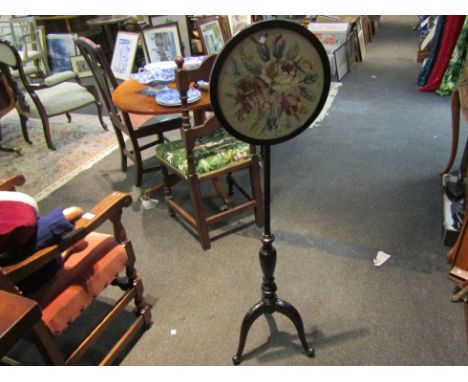 A small circular pole fire screen with floral embroidered screen, finial missing, 120cm tall