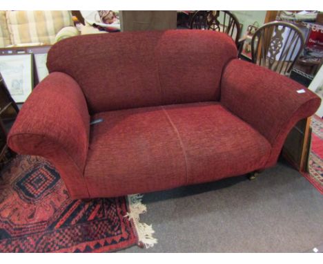 A Multiyork red coloured two seater sofa    