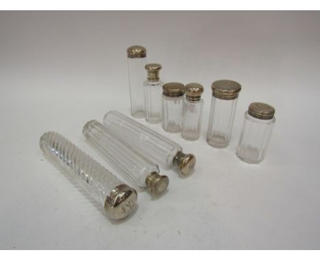 Nine various dressing table bottles six with silver tops 