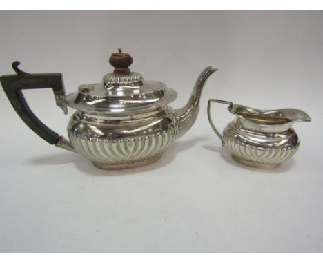 A silver two piece tea set with treen knop and handle, both damaged, Birmingham 1912 &amp; 1913, 427g