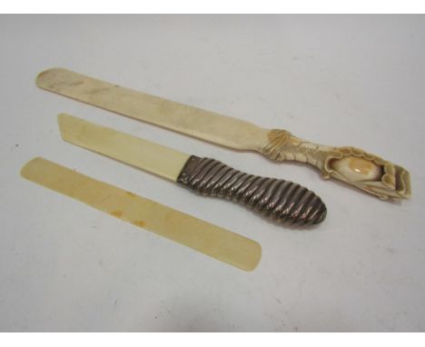 A collection of ivory to include; a carved handle page turner in the form of a dragon claw and egg, a silver handled page cut