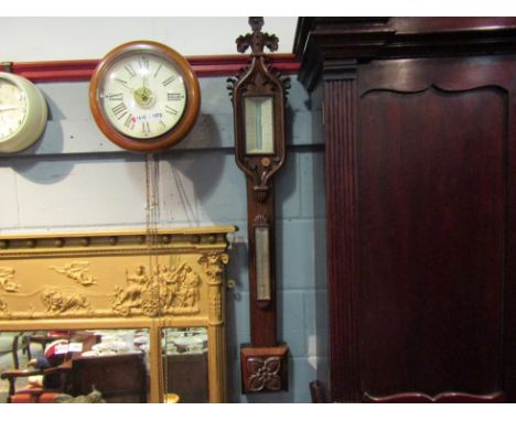 A Gothic style carved stick barometer in rosewood