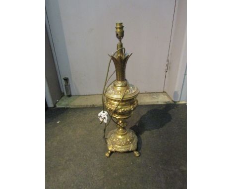 An ornate brass lamp base (possibly an oil lamp conversion)