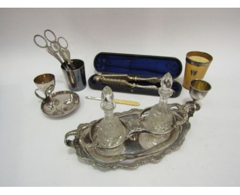 A collection of silver and silver plated wares to include; hallmarked egg cup, two pairs of grape scissors, a lobster claw cr