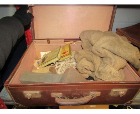 A suitcase of vintage fishing accessories to include fishing reels, rope, weights, etc. 
