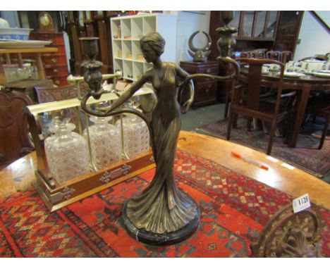 A bronzed twin sconce figural candlestick as semi-clad maiden 