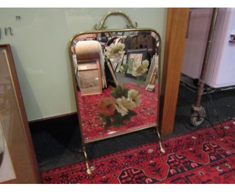 A brass painted mirror fire screen