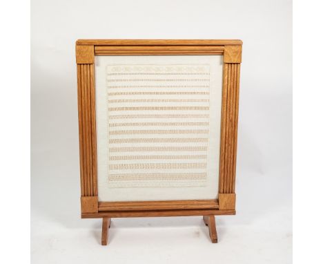 MODERN CARVED LIGHT OAK FIRESCREEN, with fluted uprights and flat top and glazed central panel hand worked with rows of pulle