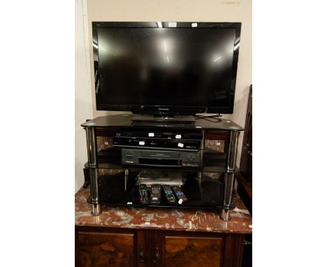 A PANASONIC FLAT SCREEN COLOUR TELEVISION, A RECORDER, VIDEO TAPE PLAYER AND A BLUE-RAY DISC PLAYER ALL ON A THREE TIER STAND