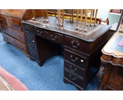 MODERN REPRODUCTION DARK OAK TWIN PEDESTAL DESK, with gilt tooled 'antique' brown leather inset top, and bracket feet
