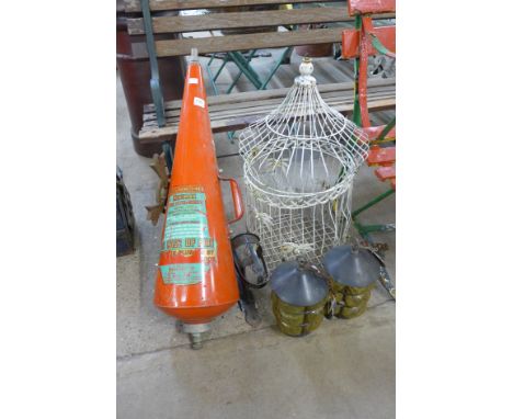 A wire bird cage, cast iron cross pair of lantern lights and a vintage Minimax fire extinguisher