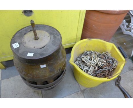 Assorted vintage steel chains and a converted cartwheel hub