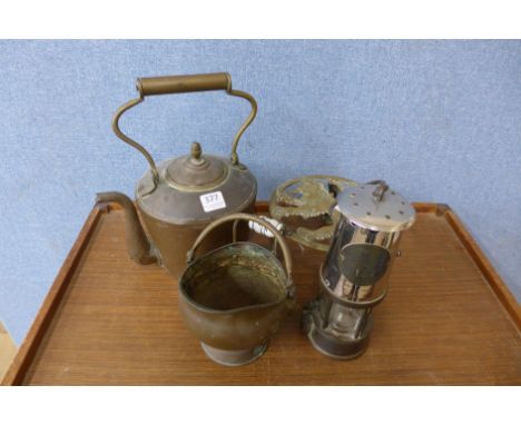 A vintage miner's lamp, a copper kettle, a brass trivet and a small copper bucket
