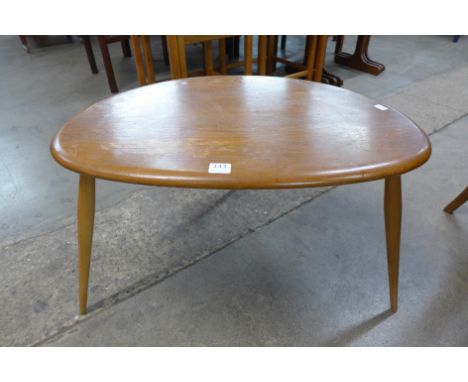 An Ercol pebble shaped occasional table