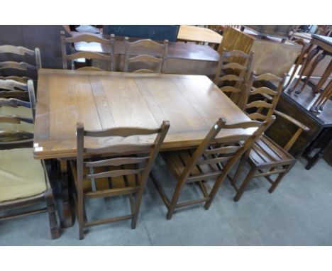 An Ercol draw-leaf dining table and six chairs