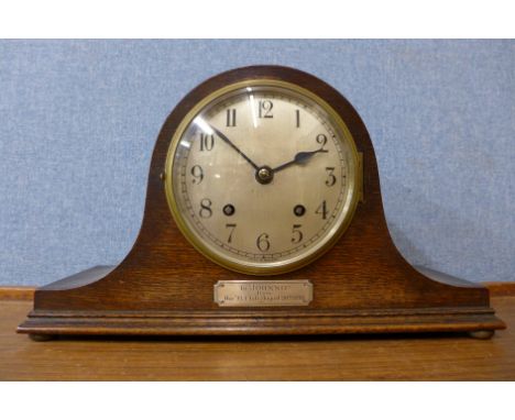 An oak mantel clock with striking movement, the movement marked Empire, made in England, inscription on front