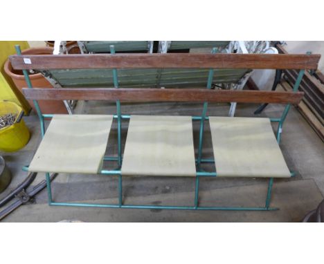 A folding steel three seater bench