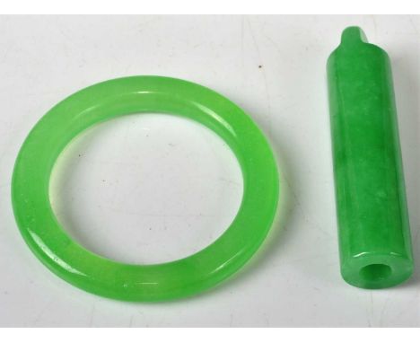 A polished green hardstone small bangle; together with a similar green hardstone cylindrical pendant (2)