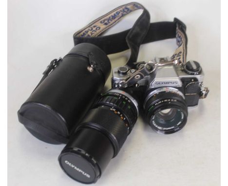 An Olympus OM10 camera, together with a collection of further various camera lenses, accessories, two shoulder bags etc