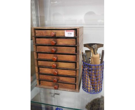 A bookbinders box of type trays; together with a selection of brass bookbinder finishing tools