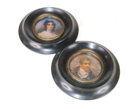 A pair of reproduction portrait miniatures, of a lady and gentleman within circular ebonised surrounds, 13.5cm
