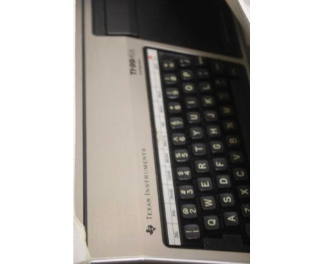 A Texas Instruments TI-99/4A computer, with controller, power leads, and manual; together with an Acorn Electron keyboard