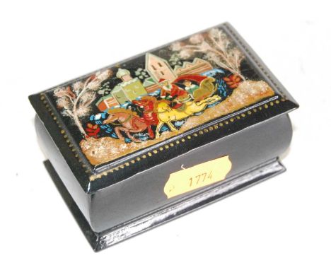 In the manner of Fedoskino, a 20th century black lacquered snuff box, the hinged rectangular cover decorated with a Troika wi