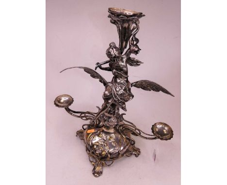 An early 20th century WMF silver plated three-branch table candelabra, the central sconce raised above a woman seated on a ba