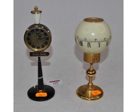 A 20th century alarm clock in the form of a street lamp for the Moulin Rouge, having a circular dial with Roman numerals, on 