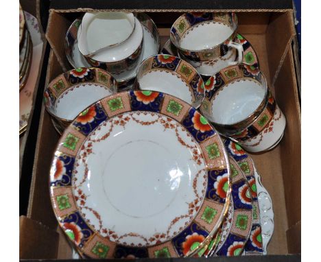 An early 20th century porcelain part tea service, with cobalt blue and iron red floral decoration