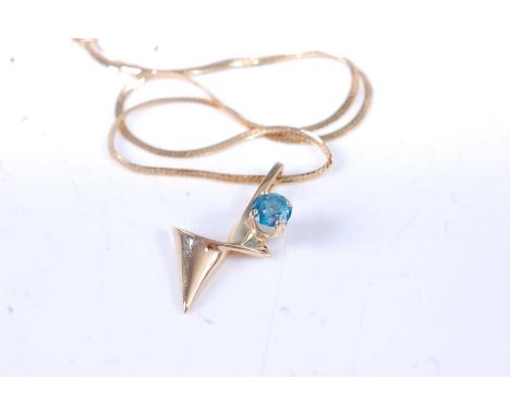 A modern 14ct gold and blue topaz set pendant, 30mm, on 14ct gold flatlink neck chain, gross weight 5.9g