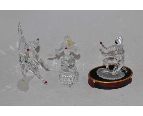 A set of three Swarovski cut crystal figures, being Masquerade Harlequin, Masquerade Columbine and Masquerade Pierrot, each b