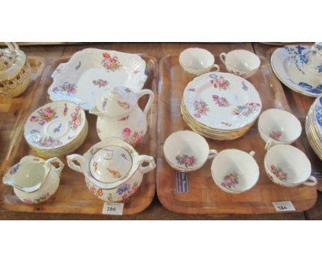 Two trays of Coalport A.D.1750 teaware items on a white ground with floral sprays comprising: teacups and saucers; lidded suc