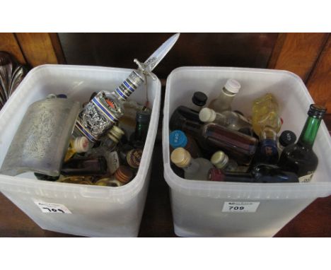 Two plastic boxes containing assorted alcoholic miniatures to include: Bell's Scotch Whisky; Guinness; Gins; Captain Morgan C