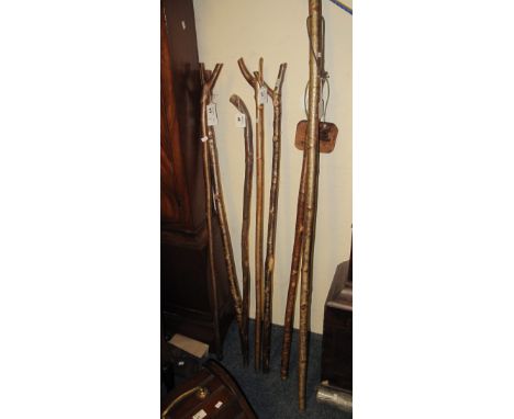 Collection of assorted, mainly hazel, thumb sticks, and a wading stick. (8)