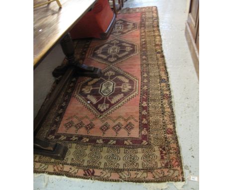 20th Century Iranian geometric runner or carpet on a salmon ground.