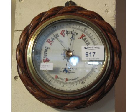 Small oak framed aneroid barometer marked: F. Greenslade, High Street, Western-Super-Mare.