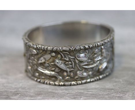 Chinese silver hinged bangle, cast fish, crabs, shrimp and seashells depicted in relief amongst sea anemones, cast decorative